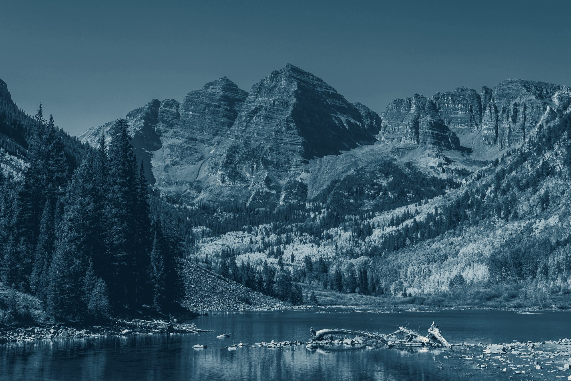The Maroon Bells reflected in a still alpine lake